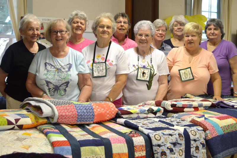 The members of the Paskamansett Quilters who worked on the 11 quilts being donated to veterans' housing. From left: Joyce Winship, Diane Crook, Mary Coutu, Bee Bettencourt, Carolyn Brehaut, Rita Oliver, Annette Cook, Terry Cook, Elizabeth Pariseau, Annette Garant. BY SETH THOMAS