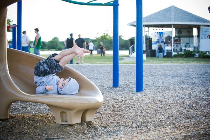 Five-year-old Gianni Rogers enjoys the slide while the band plays in the background BY DOLLY GENANNT