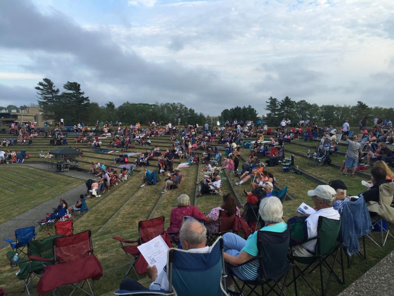 Attendees set up chairs and blankets around the Vietnam Veterans Peace Memorial Amphitheater before dusk. BY ANGIE HILSMAN