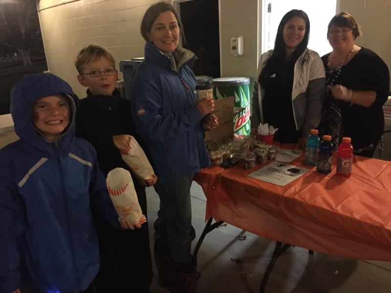 Corey Sullivan (11), Will Fairfax (10), Susan Fairfax, Victoria Gracia, and Karen Costa gather around concessions. BY ANGIE HILSMAN