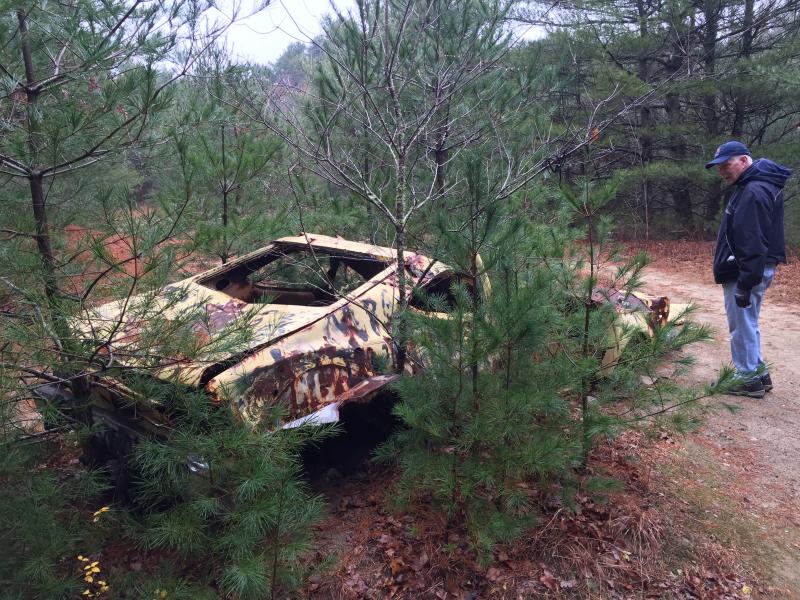 Harold Isaksen tries to figure out what sort of car was left on town-owned property. BY ANGIE HILSMAN