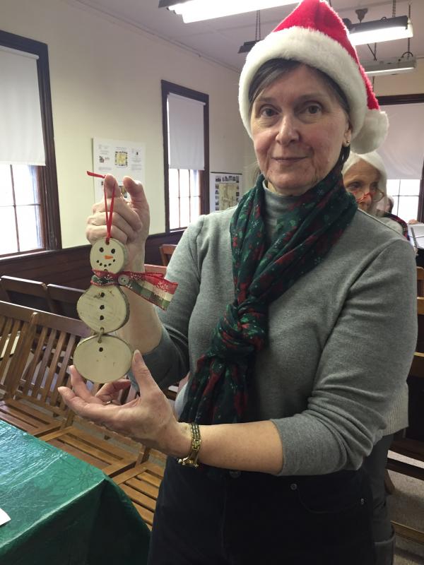 Kathy Plant of the Dartmouth Historical & Arts Society organizes crafts for visitors at the 1871 Schoolhouse. BY ANGIE HILSMAN