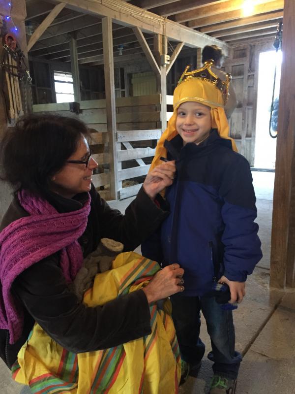 Dawn Thibeault helps her grandson, Chase Thibeault, 5, into his costume for the live nativity at Alderbrook Farm. BY ANGIE HILSMAN