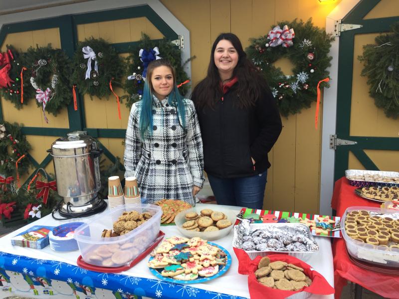 Lea Smith, 14, and Emily Vieira, 15, sell hot chocolate and cookies at Alderbrook Farm. BY ANGIE HILSMAN