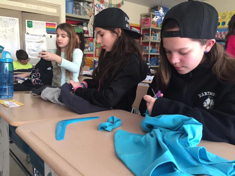 Kayleigh Hull, Joline Sahady, and Alexus Mosher create reusable bags out of t-shirts. BY ANGIE HILSMAN