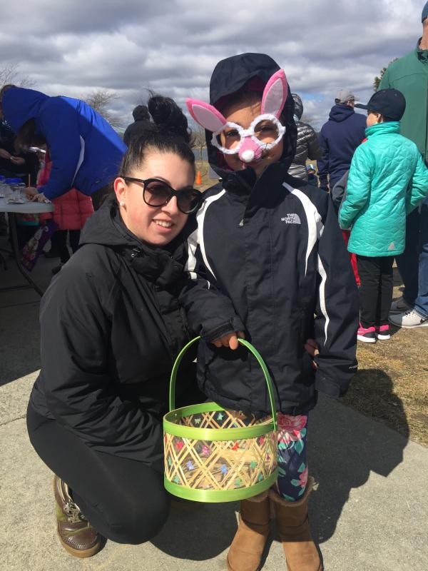 Brittany Brasells and six-year-old daughter A'mya Acevedo withstand the cold in hopes of chocolate. BY ANGIE HILSMAN