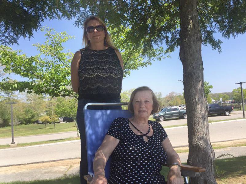 Dartmouth residents Betsy Belo and Maria Lopes watch the festivities from the shade. BY ANGIE HILSMAN