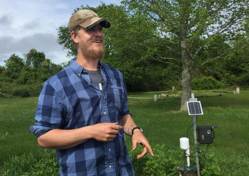 Sharing the Harvest Community Farm Director Dan King shows off a WelIntel groundwater gauge. BY ANGIE HILSMAN