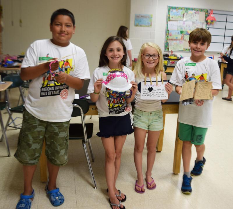 Carlos Jeronimo, Annie O'Neil, Ella Plouffe, and Colin Kelly show off their duct tape inventions. BY DOUGLAS MCCULLOCH