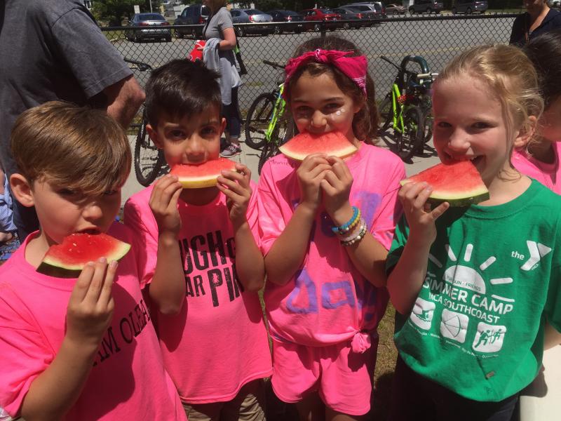 Third graders Cole Kelley, Seth Fern, Emerson White, and Jillian Dubois dig into watermelon slices. BY ANGIE HILSMAN