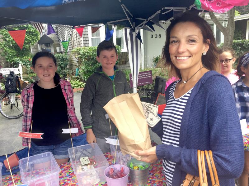 Patricia Baptiste buys candy for her kids from "Sometimes Sweet" owners Natalie and Connor Murphy. BY ANGIE HILSMAN