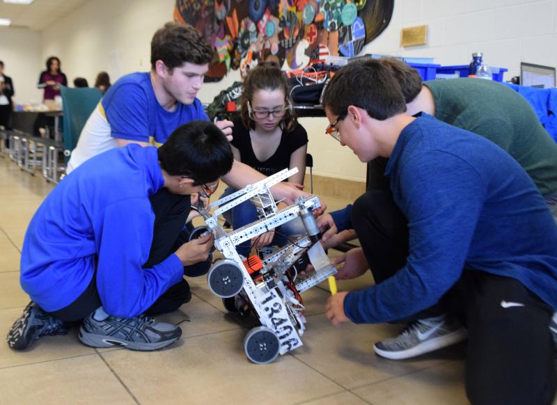 Dartmouth High students William Fang, Connor Alves, Madison Meehan, Alex Vieira, and Michael Anderson work on the PlasticGears robot. BY DOUGLAS MCCULLOCH