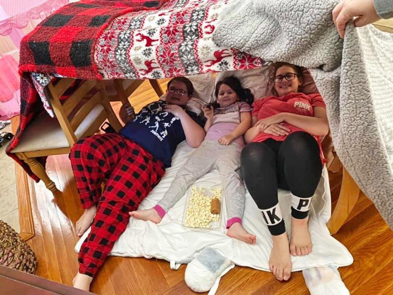 Jack Novo, 14, with sisters Charlotte, 6, and Lauren, 15, getting ready to watch movies in their fort. Photo courtesy: Andrea Camarao Novo