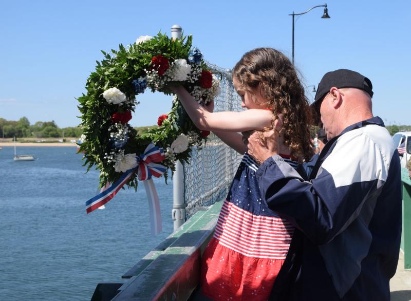 Dartmouth Week - Dartmouth, MA news - Lauren Rose-Wells and her grandfather, Norman Giovannini conduct the wreath throwing ceremony on the Padanaram Bridge. Photo by: Douglas McCulloch