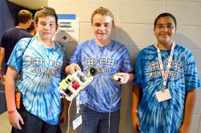 Cody Dickinson, Matt Fischer and Ryan Bankhead, a group of 14 year olds from Littleton, Colorado, show off their robot during the SeaPerch Competition. BY SETH THOMAS