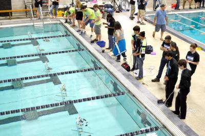 The "finesse challenge" required robots to use a probe to manipulate objects in the pool. BY SETH THOMAS