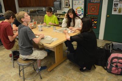 Student teacher Melissa Robson helps a group of students troubleshoot their art projects. BY SETH THOMAS