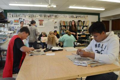 Kenny (left) and Daniel (right) work on their ceramic tile project at Friends Academy. BY SETH THOMAS