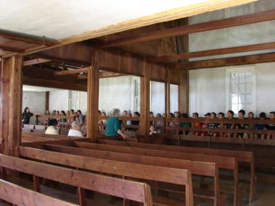 Students line the pews of the Apponagansett Meeting House during their recent tour of Dartmouth's most historic structures. BY LISA ARRUDA