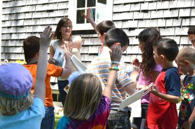 Grace Labossiere asks for a participant to read the first clue during the scavenger hunt at the Akin House. BY SETH THOMAS