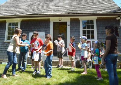 The group stands in front of the Akin House listening to a clue during the scavenger hunt. BY SETH THOMAS