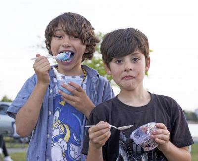 Elijah Tavares, 8, and Mason Marshall, 8, have some ice cream from the Gulf Hill Bucket at the year’s first Apponagansett Park summer concert Wednesday evening. Photo by: Nick Walecka BY NICK WALECKA