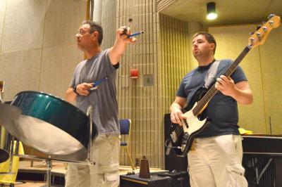 Jamie Eckert and Jack Harrison, members of El Caribe, practice before they head onto the stage. BY SETH THOMAS