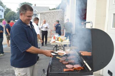 Rain held out Wednesday evening so that Lieutenant Pete Andrade could grill hamburgers and hotdogs during the cookout. BY SETH THOMAS