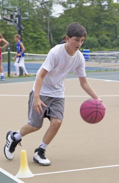 A player dribbles by a cone during Monday morning's skills clinic hosted by Avery Bradley. BY NICK WALECKA