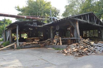 The main shed of the sawmill. The pipes up top are used to funnel sawdust to a different part of the property. The dust is transported through the pipes with air pressure. BY SETH THOMAS
