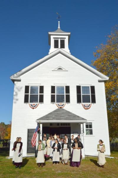 Dartmouth High school students from the early childhood education program wait for the third graders to arrive at the Russells Mills Schoolhouse. BY SETH THOMAS
