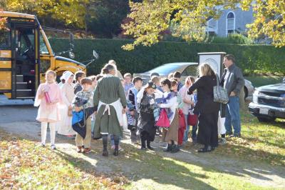 Sue Guiducci, chair of the Education Committee for the Dartmouth Historical and Arts Society, greets Jasmine Olean's third grade class. BY SETH THOMAS