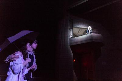 Janet and Brad (Megan Sullivan and Johnny Perreira) suspect nothing's the matter as Riff Raff (Nolan Raymond) sings from the balcony. BY LAUREN ZAKNOUN