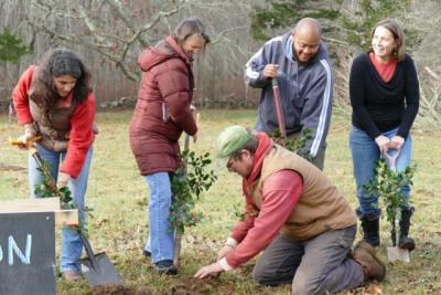 Round the Bend staffers dig into the ground with shovels adorned with holly during their ground awakening ceremony for the new building. COURTESY DESA VANLAARHOVEN