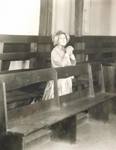 Patience Morgan, played by Marguerite Courtot, prays in the Meeting House. Courtesy of: New Bedford Whaling Museum