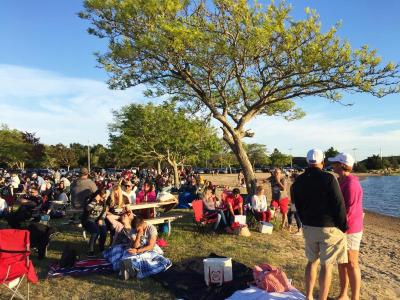 People watched the sun set on the beach and listened to the music