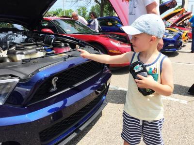 Max Moniz, 4, holds a toy Miatta while pointing out his favorite car
