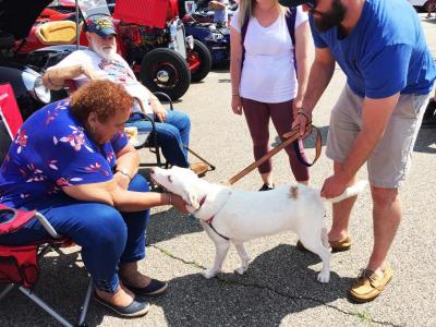 Dolores Faber greets one-year-old pup Luna at the car show
