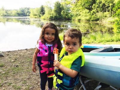 Elisabeth, 3, and her two-year-old brother Nathaniel ready themselves for a family kayak trip on Cornell Pond