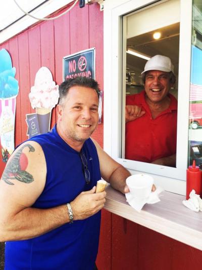 Kevin Castino eats his ice cream while former farm owner Bill Coutu looks on