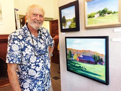 Painter and printmaker Jim Sears next to an oil painting of a farm on Rock O’Dundee Road