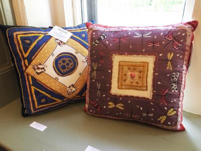 Whimsical quilted pillow collages by Marjorie Durko Puryear on display