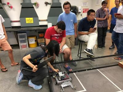 Minhong Chang makes a last-minute adjustment to his team’s robot before starting the competition.