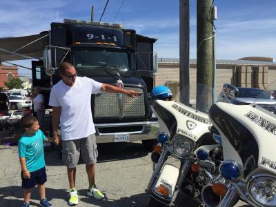 Leyden Leite, 4, admires the Dartmouth Police motorcycles with his father John.