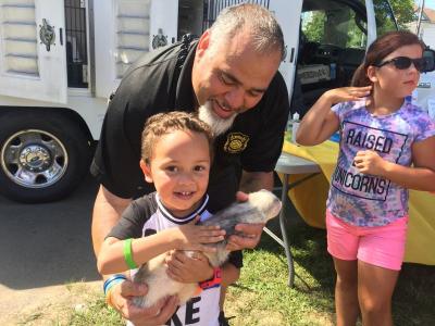 Javen Rivera, 4, holds Slinky the ferret while Director of New Bedford Animal Control Emanuel Maciel helps. All of the animals were rescued from cruelty cases.
