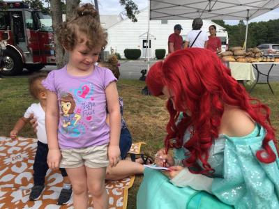 Sophia Morelli, 4, gets an autograph from the princess.