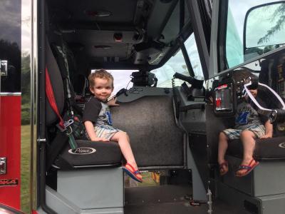 Meanwhile Sophia’s brother Teddy, 2, perches happily inside the fire truck.