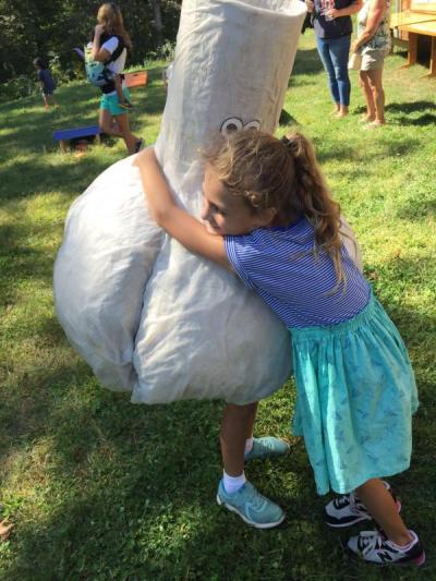 Fiona McGrath, 6, hugs her sister Faye, 9, who is dressed as a bulb of garlic.