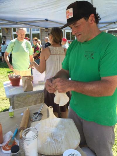Philip Cook of Westport’s Quintessential Gardens stretches out pizza dough for wood-fired pizzas.