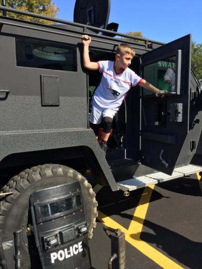 Jaxon Lussier, 7, of Fairhaven climbs out of the S.W.A.T. van before the ceremony.
